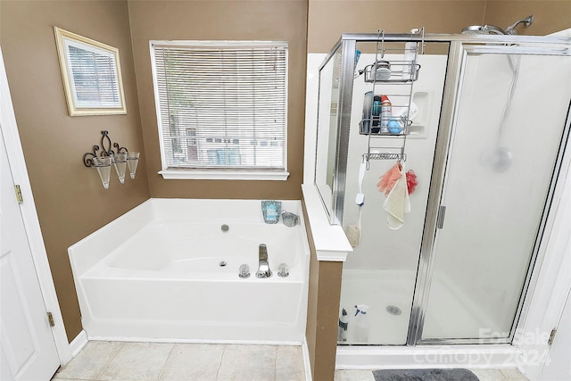 bathroom featuring tile patterned floors and independent shower and bath