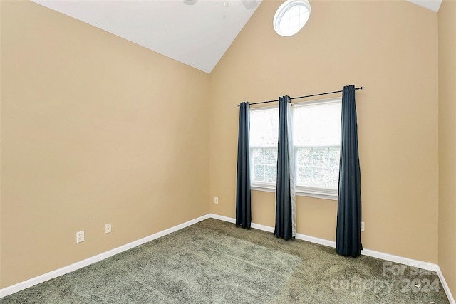 carpeted spare room featuring lofted ceiling