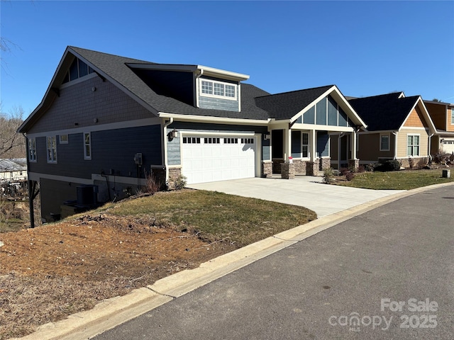 craftsman-style house with central air condition unit and a garage