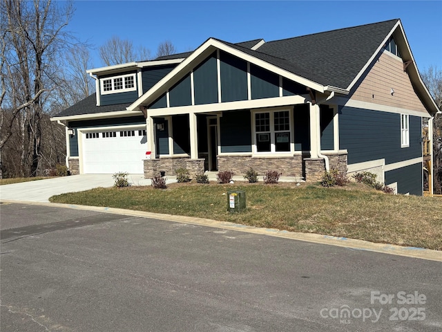 craftsman-style home with a porch, a garage, and a front yard