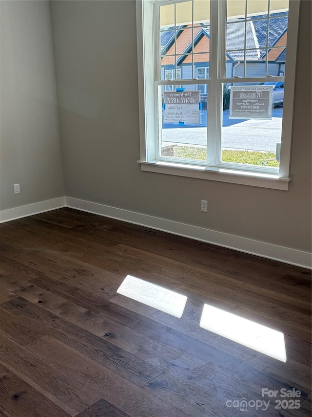 empty room featuring dark hardwood / wood-style flooring