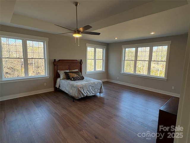 bedroom with dark hardwood / wood-style flooring and ceiling fan