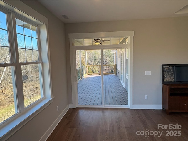 doorway to outside featuring ceiling fan, plenty of natural light, and dark hardwood / wood-style floors