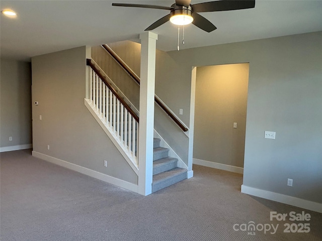 stairs with ceiling fan and carpet