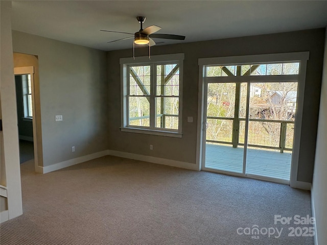 carpeted spare room featuring ceiling fan