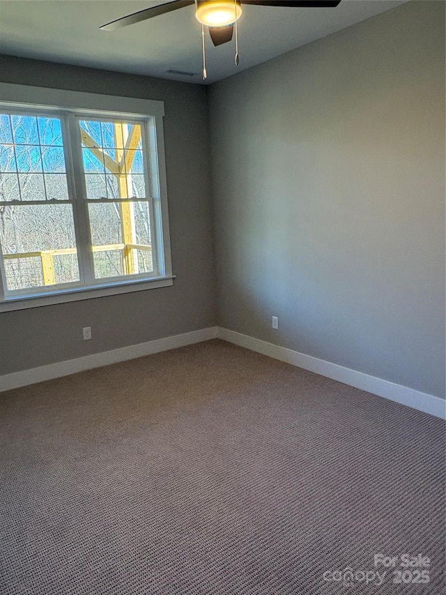 unfurnished room featuring carpet floors, ceiling fan, and a wealth of natural light