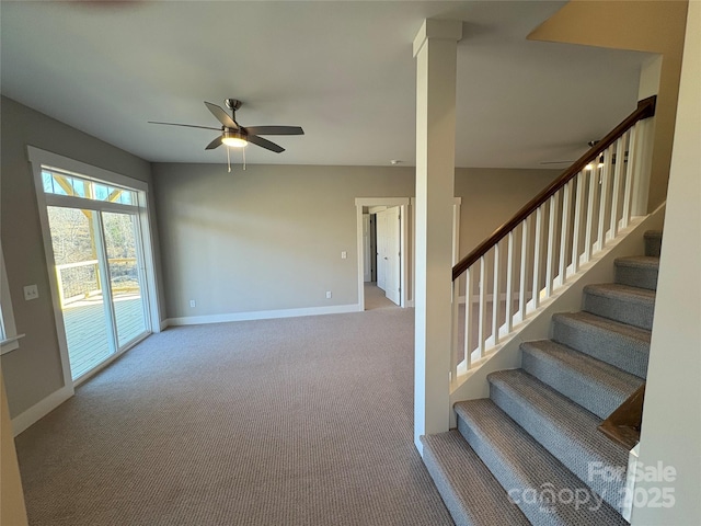 staircase featuring ceiling fan and carpet