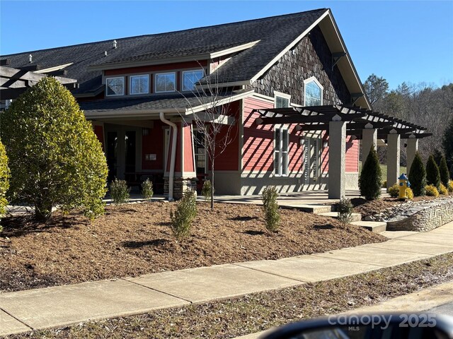 view of front facade with a pergola and covered porch