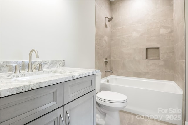 full bath with tile patterned floors, shower / bathtub combination, vanity, and toilet