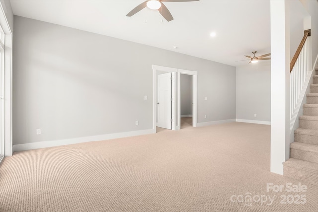 interior space with ceiling fan, light carpet, and stairs