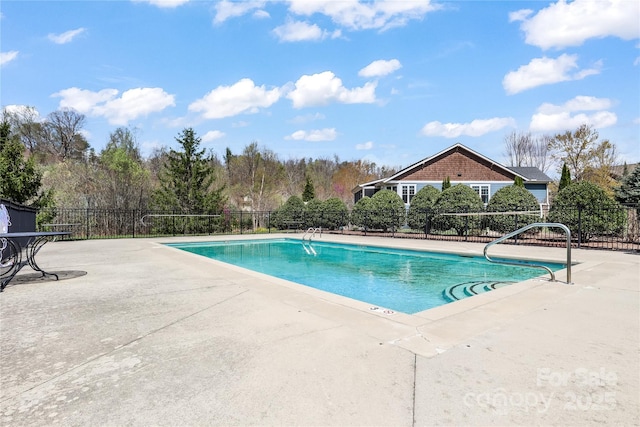 community pool featuring a patio area and fence