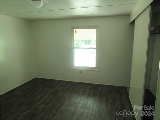 empty room featuring dark hardwood / wood-style floors