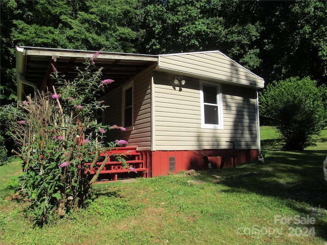 view of side of property with a yard