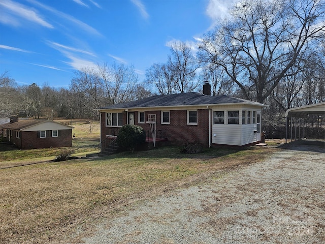 back of house featuring a yard and a carport