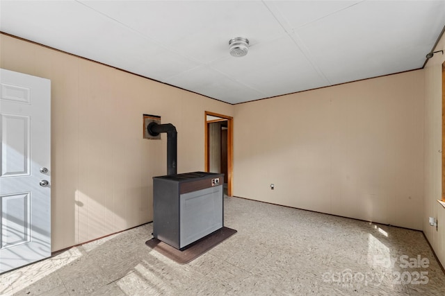 spare room featuring a wood stove