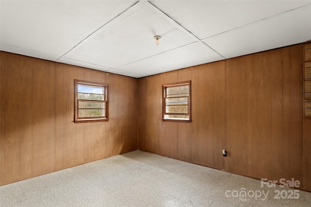 spare room with wooden walls