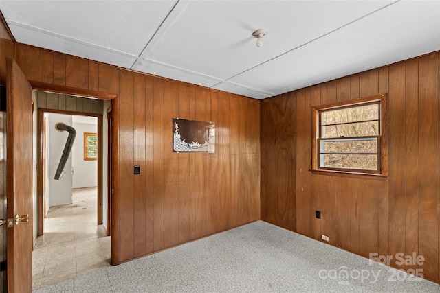 spare room with wooden walls
