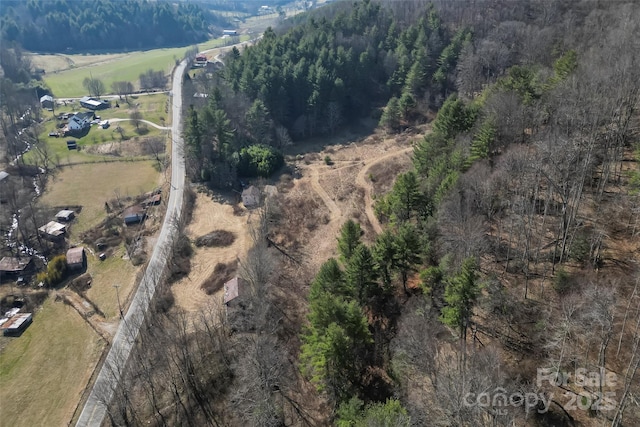 aerial view with a wooded view and a rural view
