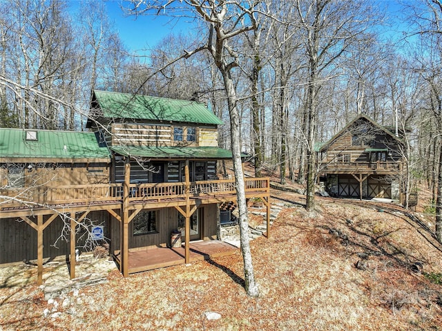 rear view of house featuring a deck and a patio