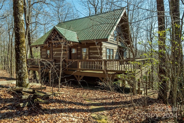 rear view of house featuring a wooden deck