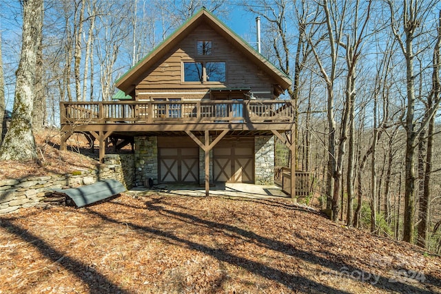 view of front of home with a deck and a garage