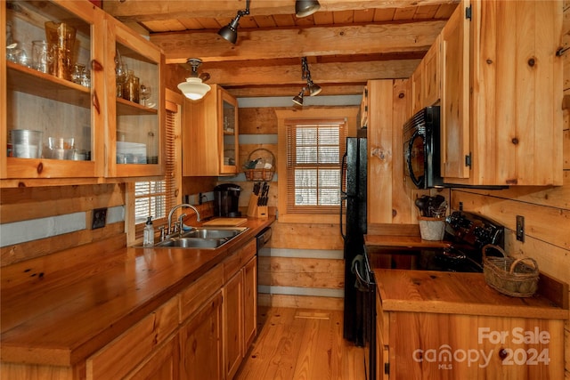 kitchen with black appliances, sink, light wood-type flooring, beam ceiling, and wooden ceiling