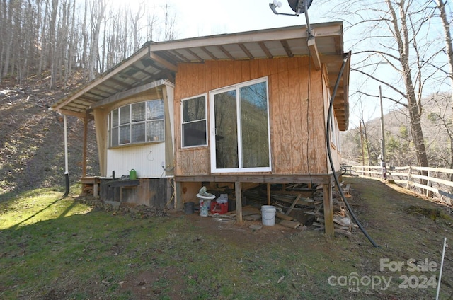 view of property exterior featuring a lawn