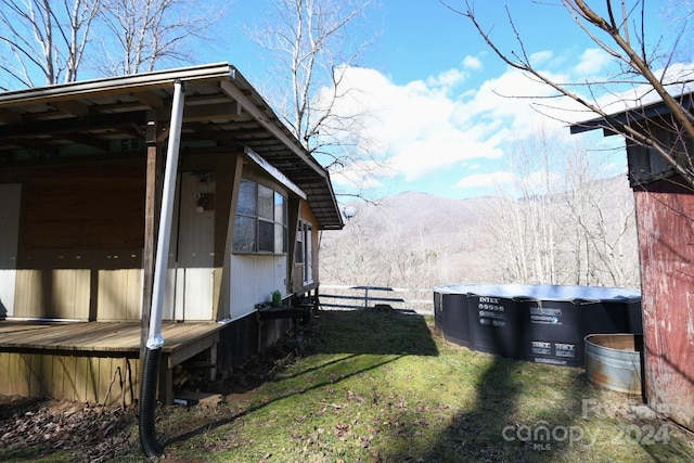 view of property exterior featuring a lawn and a mountain view