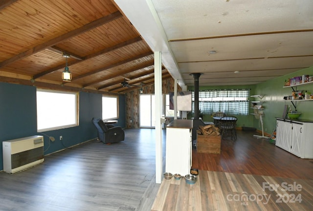 interior space featuring wood ceiling, beam ceiling, a wood stove, and dark hardwood / wood-style flooring