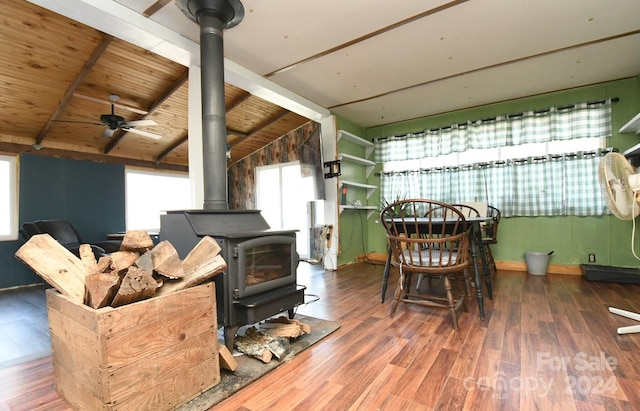 living room featuring wood ceiling, a wood stove, dark hardwood / wood-style floors, and lofted ceiling with beams