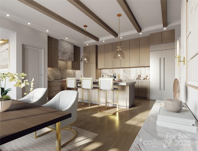 kitchen with a breakfast bar area, decorative light fixtures, dark hardwood / wood-style flooring, beam ceiling, and backsplash