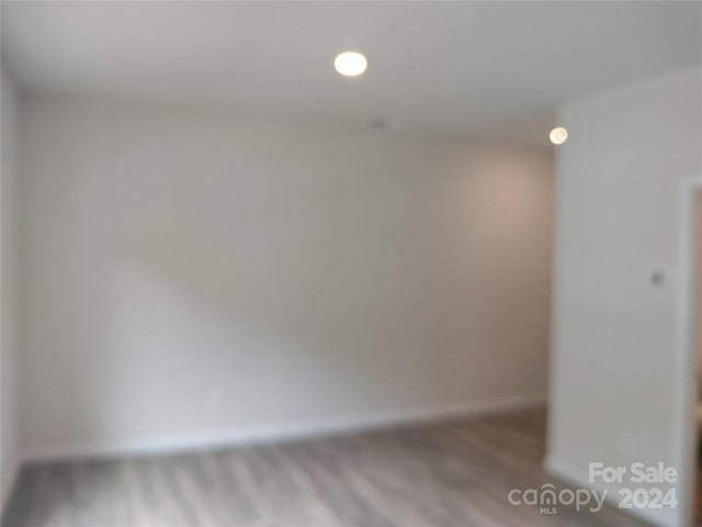 spare room with wood-type flooring