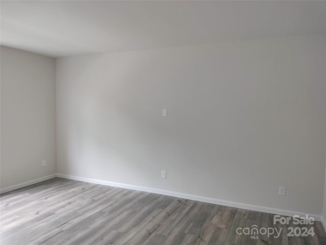 unfurnished room with light wood-type flooring