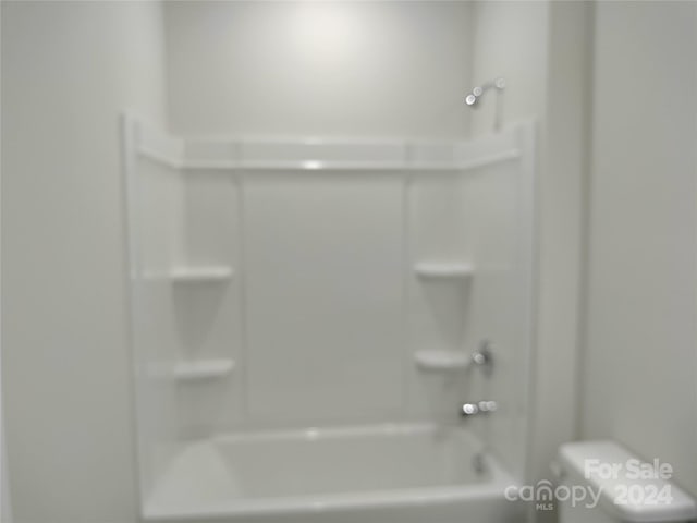 bathroom featuring toilet and bathtub / shower combination