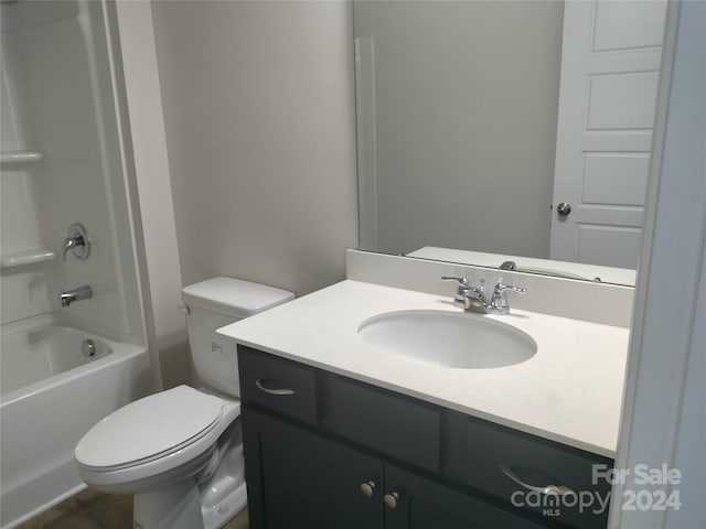 full bathroom with bathtub / shower combination, vanity, and toilet