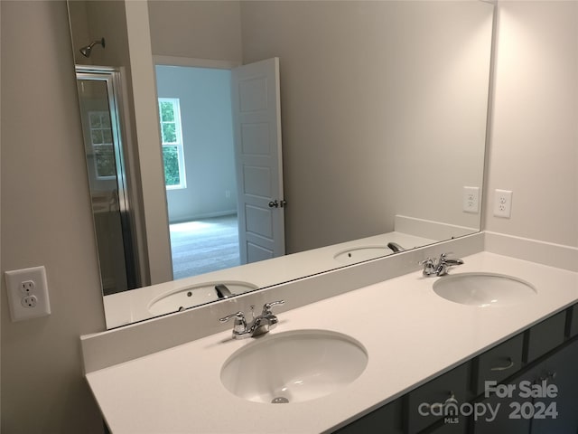 bathroom featuring vanity and a shower with door