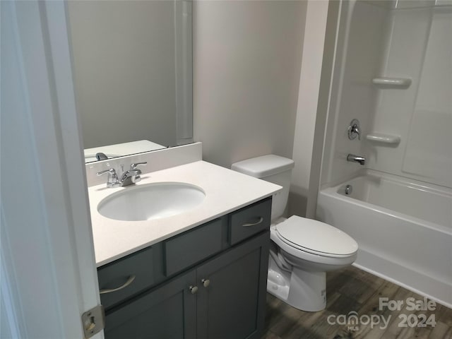 full bathroom with toilet, shower / tub combination, vanity, and wood-type flooring