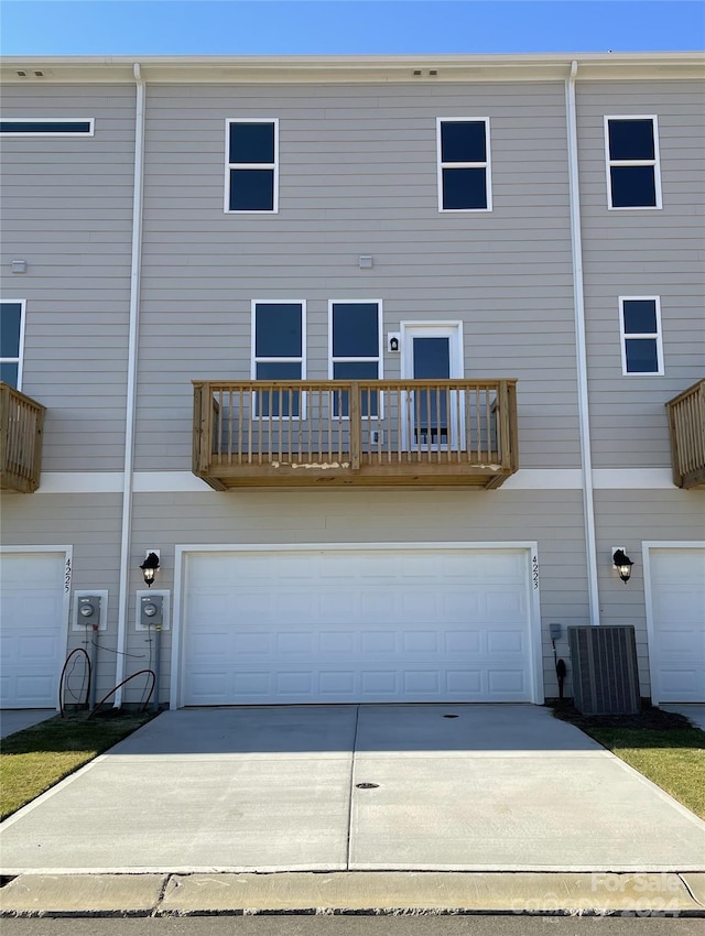 back of house featuring a garage and a balcony