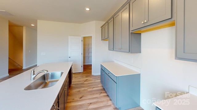 4223 S New Hope Rd Unit 8, Gastonia, NC 28056 - kitchen with light wood finished floors, recessed lighting, light countertops, blue cabinets, and gray cabinets