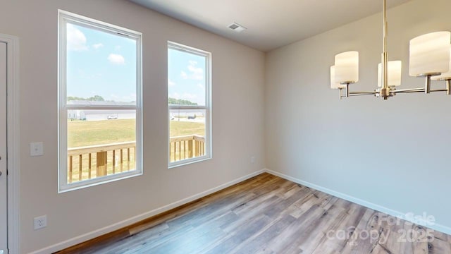 4223 S New Hope Rd Unit 8, Gastonia, NC 28056 - empty room featuring wood finished floors and a chandelier