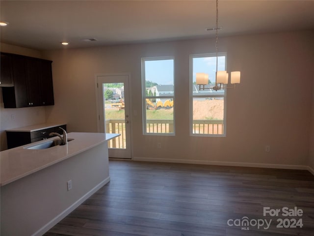 kitchen featuring pendant lighting, an inviting chandelier, sink, dark hardwood / wood-style floors, and dark brown cabinetry