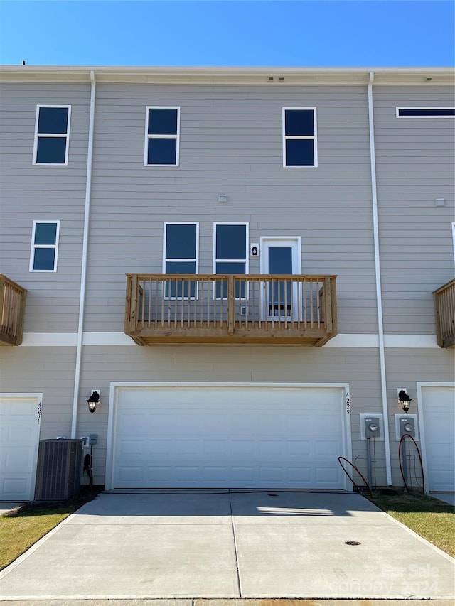 back of property featuring central AC and a balcony