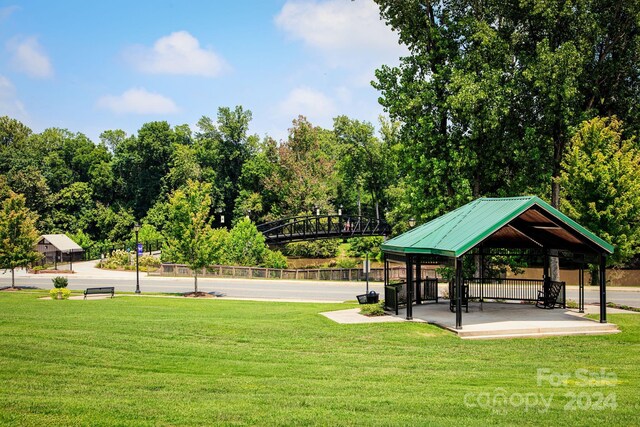 surrounding community with a gazebo and a lawn