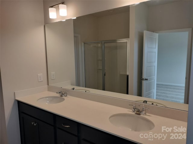 bathroom with a shower with door and vanity