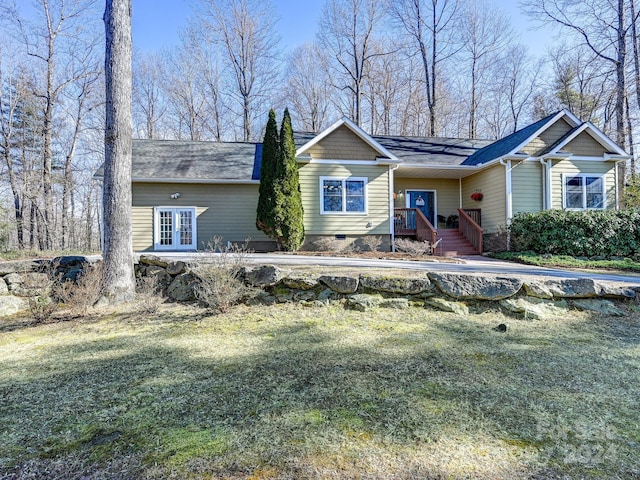 ranch-style house featuring french doors and a front yard