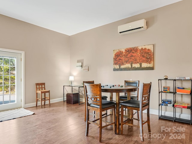 dining space featuring hardwood / wood-style flooring and a wall unit AC