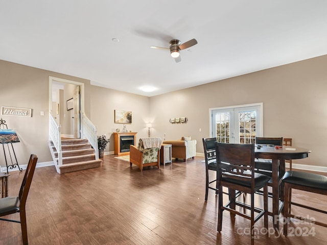 dining room with ceiling fan, french doors, and dark wood-type flooring