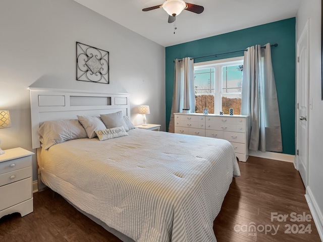 bedroom with ceiling fan and dark hardwood / wood-style floors