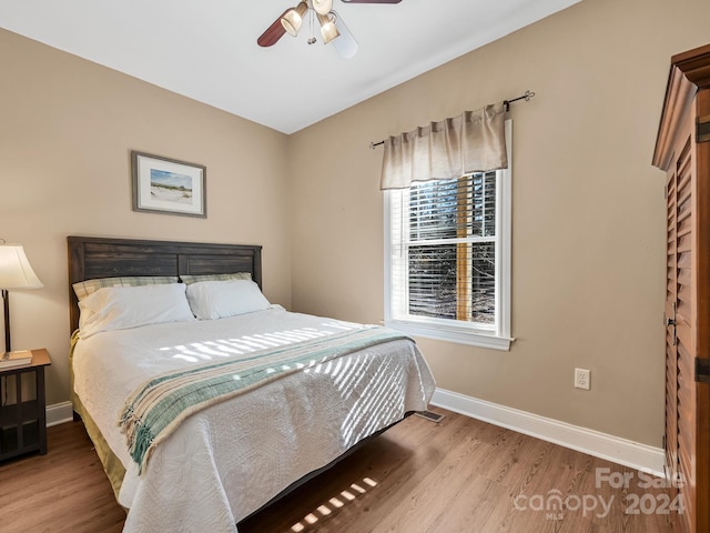 bedroom with ceiling fan and wood-type flooring