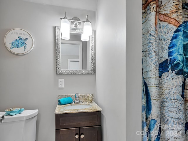 bathroom featuring toilet and vanity